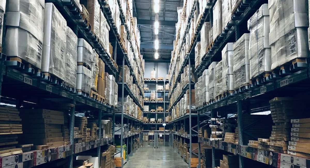 Forklift placing inventory into warehouse storage racks